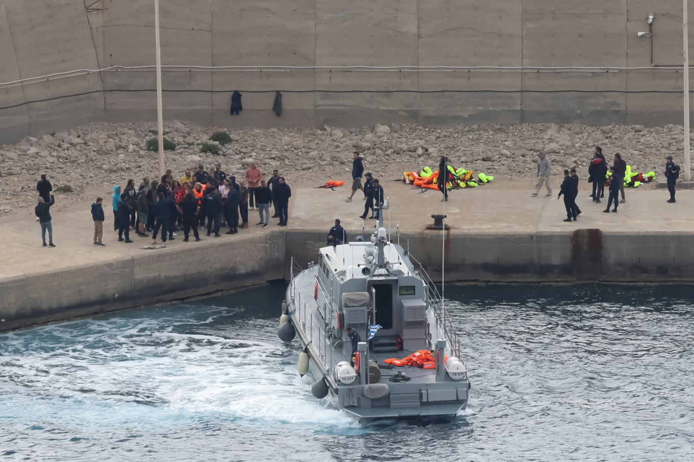 Activists from the Global Sumud aid flotilla stand at the port of Atherinolakkos on May 1 on the island of Crete after disembarking from a Greek Coast Guard vessel, following their interception by the Israeli Navy in international waters.