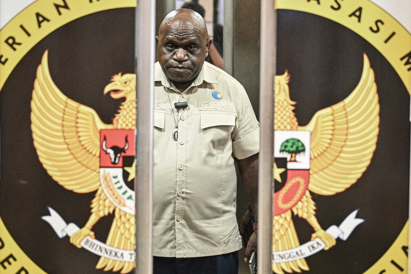 Human Rights Minister Natalius Pigai arrives at the Human Rights Ministry office in Jakarta for a press briefing on May 4, 2026.