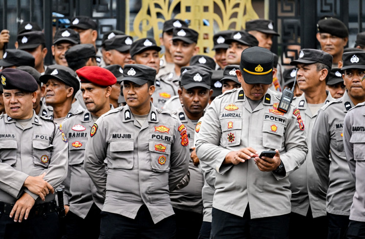 Police officers stand guard in front of the Aceh Provincial Legislative Council (DPRA) building on Sept. 1, 2025, in Banda Aceh, Aceh, during a protest by students demanding police reform and the dissolution of the House of Representatives. Thousands rallied across Indonesia on Sept. 1, as the military was deployed in Jakarta after six people were killed in nationwide protests sparked by anger over lavish perks for lawmakers.