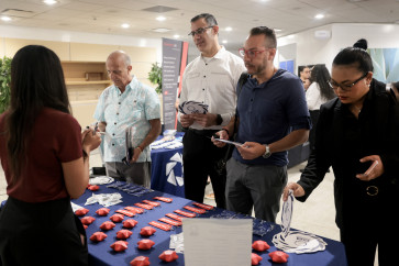 Gustavo Ospina, Angel Rios, Cesar Colon and Katherine Sloan, who worked for Spirit Airlines for 25, 25, 25, and 3 years, respectively, speak with recruiters for GA Telesis during a CareerSource South Florida job fair held at Miami International Airport for former Spirit Airlines employees on May 07, 2026, in Florida, United States. Spirit Airlines shut down on May 2.