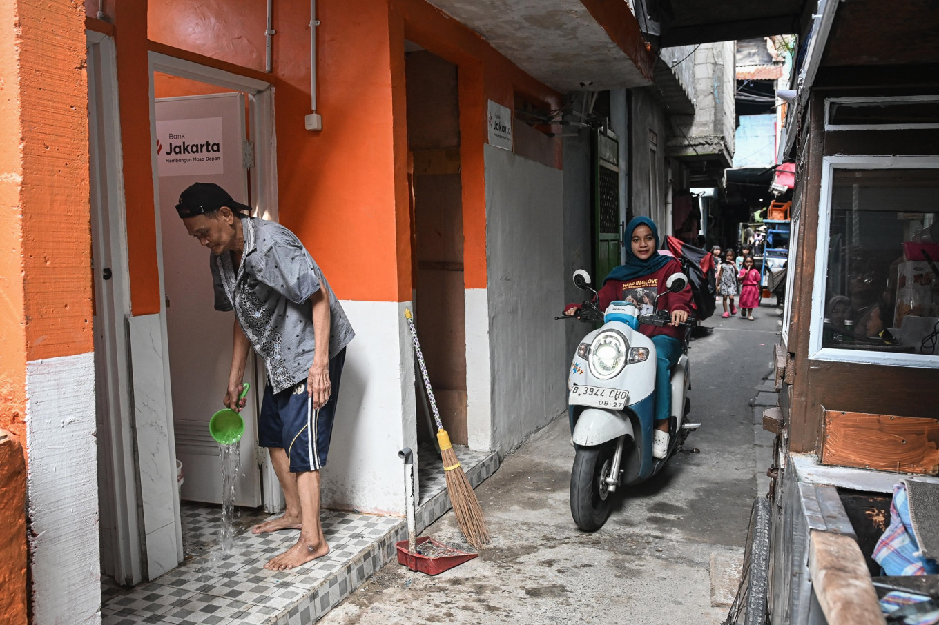 A man cleans up a communal bathroom on May 8 in Tomang subdistrict, Grogol Petamburan district, West Jakarta. Statistics Indonesia (BPS) recorded the number of community units (RW) classified as slum neighborhoods in Jakarta has decreased from 445  in 2017 to 211 this year.