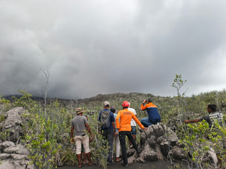 Rescue workers stand by after the volcanic eruption of Mount Dukono in North Halmahera, North Maluku, on May 8, 2026.
Three hikers died in an eruption of Mount Dukono volcano on May 8 where they found themselves in a no-go zone, officials said.
