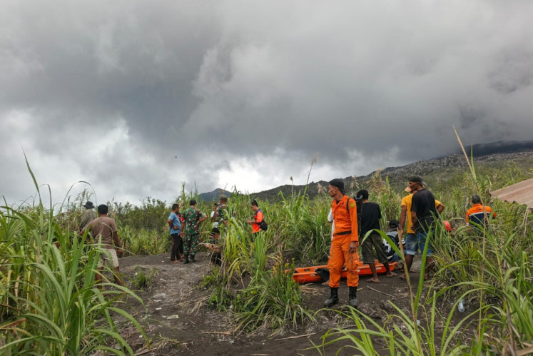 A handout picture taken and released on May 8, 2026 by the National Search and Rescue Agency (Basarnas) shows rescue workers standing by after the volcanic eruption of Mount Dukono in North Halmahera, North Maluku.