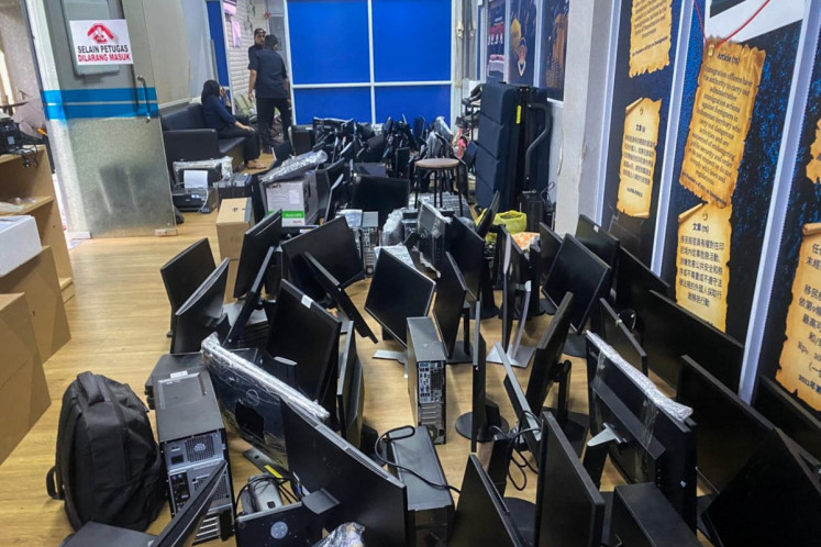 A handout picture taken on May 6 and released by the Batam Immigration Office shows computers seized during a raid by immigration authorities and police that detained 210 foreign nationals over an alleged online investment scam operation at an apartment complex in Batam in Riau Islands.
