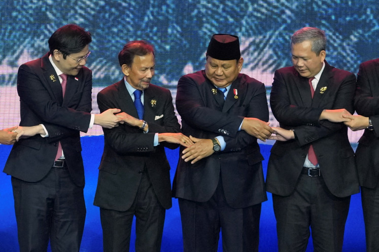 Singapore's Prime Minister Lawrence Wong, Brunei's Sultan Hassanal Bolkiah, Indonesia's President Prabowo Subianto, and Cambodia's Prime Minister Hun Manet (from left to right) hold hands for a group photo during the opening ceremony of the 48th ASEAN Summit and Related Meetings, in Cebu, Philippines, May 8, 2026. 