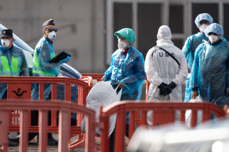 Time of crisis: Passengers wearing blue protective suits board a military bus as passengers and crew are evacuated from the Dutch flagged hantavirus-stricken cruise ship MV Hondius on Sunday, May 10, 2026, at the industrial port of Granadilla de Abona on the island of Tenerife in Spain&rsquo;s Canary Islands.