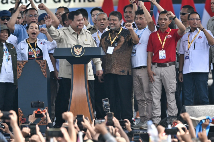President Prabowo Subianto (second left) stands with leaders of labor groups on Friday during the commemoration of Labor Day at the National Monument (Monas) complex in Jakarta. 