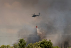 A Florida National Guard helicopter dumps water on the Max Road Miramar fire on May 11, 2026 in Pembroke Pines, Florida, United States.