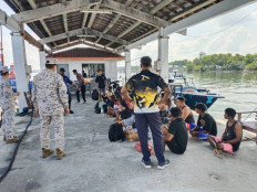 Survivors who were rescued sit after a boat believed to be carrying undocumented Indonesian migrants sank off the coast of Pangkor Island, Malaysia in this undated handout released May 12, 2026. 
