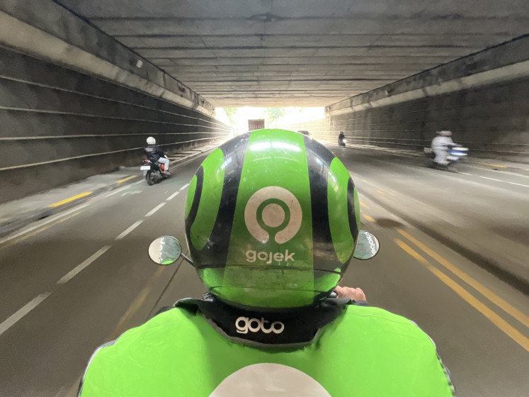 An online motorcycle taxi rider passes through the Casablanca area in South Jakarta, on May 10, 2026.