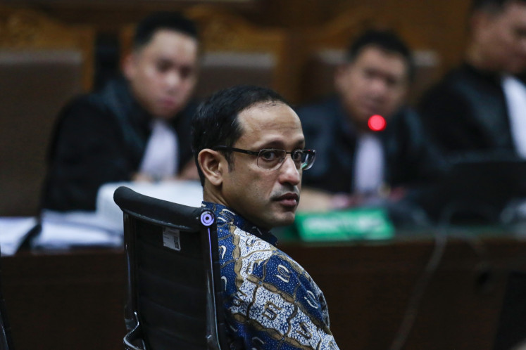 Former education minister and graft defendant Nadiem Makarim looks at the camera during a hearing on May 11 at the Jakarta Corruption Court.