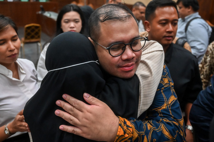 Ibrahim Arief, a suspect in a corruption case involving the procurement of Chromebook-based laptops at the then-education, culture, research and technology ministry from 2019 to 2022, embraces his wife on May 12, 2026, after attending a verdict hearing at the Jakarta Corruption Court.