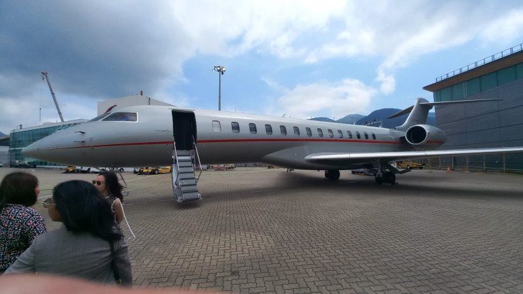 People gather in front of a VistaJet Bombardier Global 7500 ultra-long-range business jet during a static show at Hong Kong Business Aviation Center on Chek Lap Kok Island, Hong Kong, on March 27, 2024.