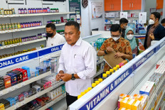Police officers visit a drug store to inspect syrup formulas for children following numerous child deaths from kidney injuries attributed to harmful substances in medicinal syrups in Banda Aceh, Aceh on Oct. 24, 2022.