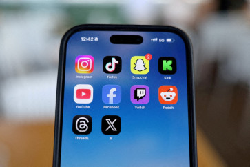 Instagram, TikTok, Snapchat, Kick, YouTube, Facebook, Twitch, Reddit, Threads and X applications are displayed on a mobile phone ahead of new law banning social media for users under 16 in Australia, in this picture illustration taken on December 9, 2025. 