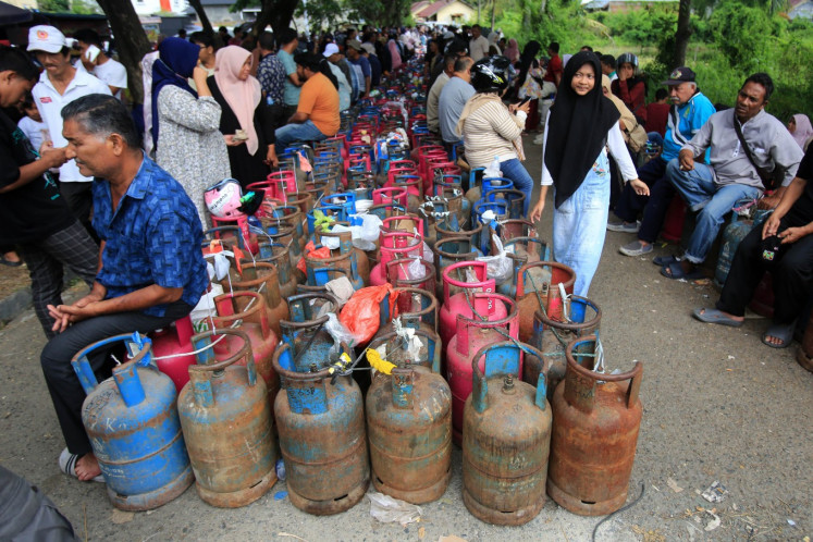 Residents line up to buy nonsubsidized liquefied petroleum gas on Dec. 13, 2025, at a PT Loon Mita Gah agency in Banda Aceh, Aceh. State energy company PT Pertamina said it is using all modes of land, air and sea transportation to ensure smooth energy distribution, including LPG, as part of recovery efforts in areas affected by floods and landslides in Sumatra. 
