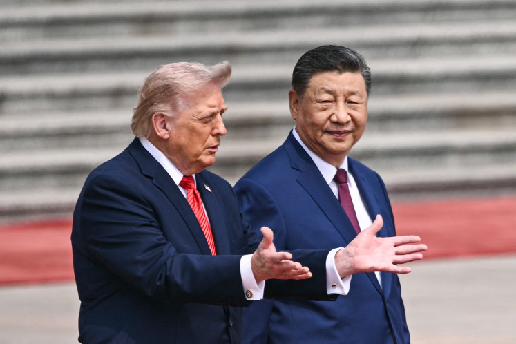 United States President Donald Trump (left) takes part in a welcome ceremony on May 14, 2026, with China's President Xi Jinping at the Great Hall of the People in Beijing.