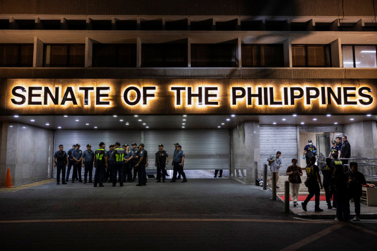 Police officers stand outside the Senate building, after gunshots were heard at the Philippine Senate, as chaos mounted in anticipation of an attempt to arrest a top senator wanted by the International Criminal Court, in Pasay City, Metro Manila, Philippines, May 13, 2026. 