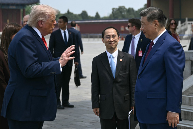 China's President Xi Jinping (right) and US President Donald Trump talk during their visit to the Temple of Heaven in Beijing on May 14, 2026.