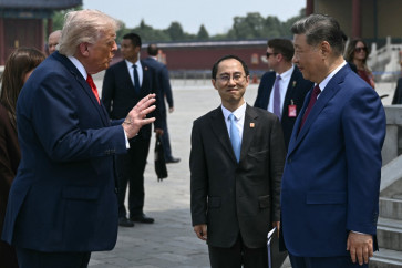 China's President Xi Jinping (right) and US President Donald Trump talk during their visit to the Temple of Heaven in Beijing on May 14, 2026.