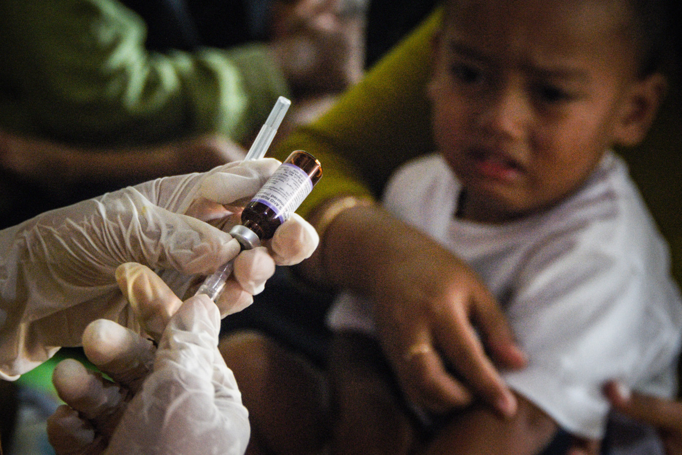 Preventive sting: A health worker prepares a measles-rubella vaccine on April 6 at an integrated health services post (Posyandu) amid a measles outbreak due to low vaccination coverage in Cikukuk, West Java.