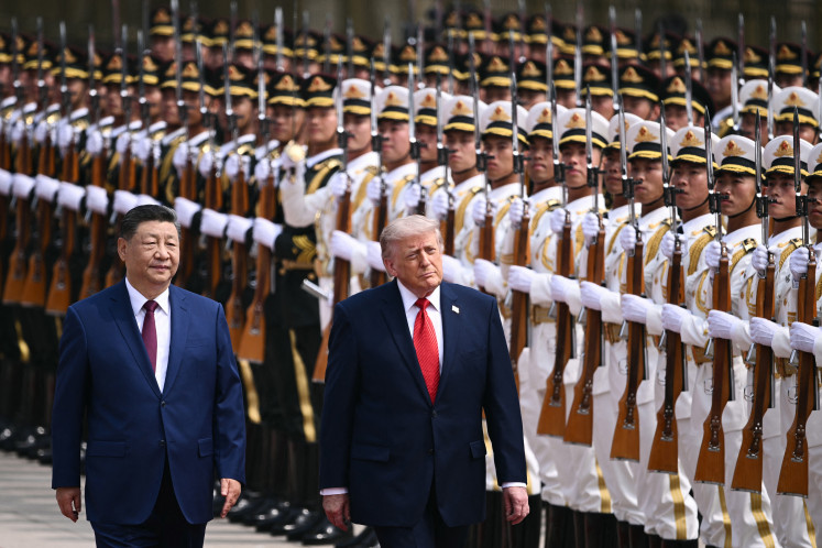Friends or foes?: United States President Donald Trump (right) and China&rsquo;s President Xi Jinping inspect a guard of honor on May 14, 2026, during a welcome ceremony at the Great Hall of the People, in Beijing.