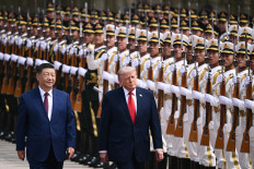 Friends or foes?: United States President Donald Trump (right) and China&rsquo;s President Xi Jinping inspect a guard of honor on May 14, 2026, during a welcome ceremony at the Great Hall of the People, in Beijing.