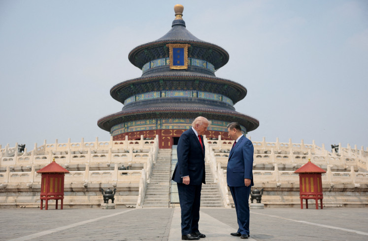 Chinese President Xi Jinping (right) and United States President Donald Trump stand facing each other on May 14, 2026, during a tour of the Temple of Heaven in Beijing.