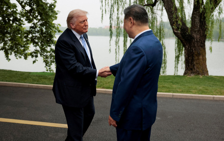 Dealmakers-in-chief: United States President Donald Trump (left) is greeted on May 15 by Chinese President Xi Jinping at Zhongnanhai Garden in Beijing.