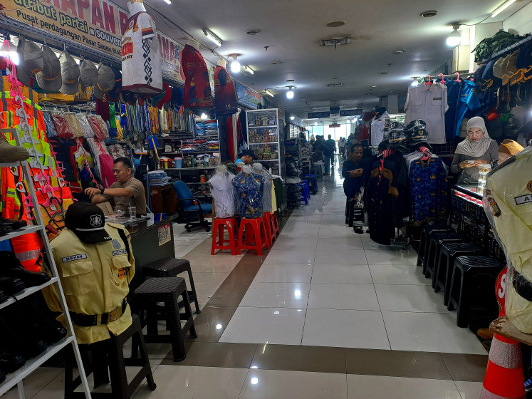 Clothing and accessories retailers wait for customers at Senen Market in Central Jakarta on May 14, 2026.