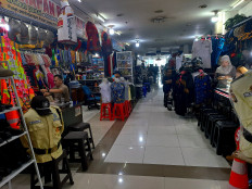 Clothing and accessories retailers wait for customers at Senen Market in Central Jakarta on May 14, 2026.
