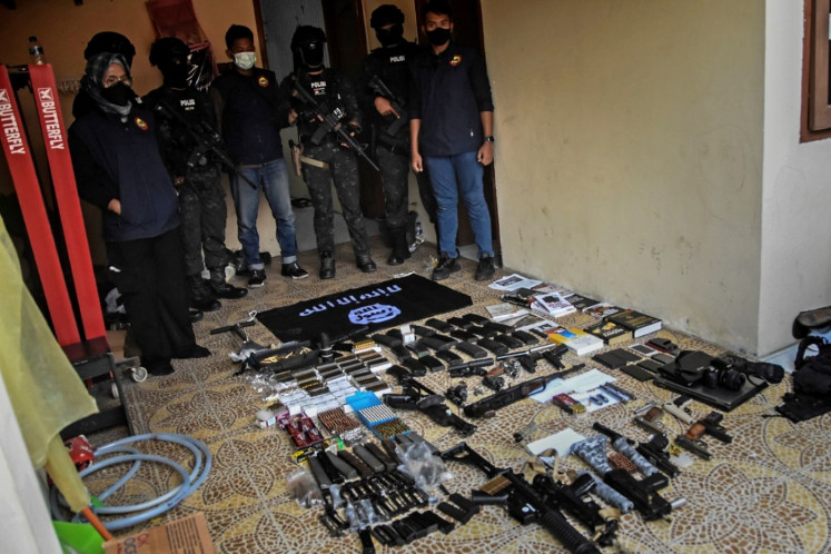 The raid: Personnel from the National Police&rsquo;s counterterrorism squad Densus 88 show seized firearms and other items following a raid on the house of an alleged sympathizer of the Islamic State movement in Bekasi, West Java, on Aug. 14, 2023. 