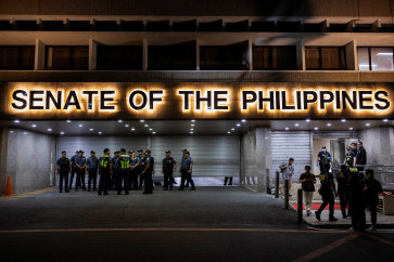Police officers stand outside the Senate building in Pasay City, Metro Manila, the Philippines, on May 13, 2026, after gunshots were heard at the Philippine Senate, as chaos mounted in anticipation of an attempt to arrest a top senator wanted by the International Criminal Court (ICC).
