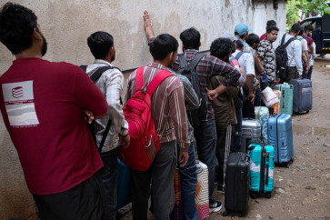 Sri Lankan police personnel escort detained Indian and Nepalese nationals suspected of running cyber fraud centers, to a court in Galle on May 12, 2026. Sri Lanka police arrested 221 foreigners, mostly Indians, in four locations in the latest crackdown on cyber scam centers mushrooming in the South Asian nation, it was announced on May 12.