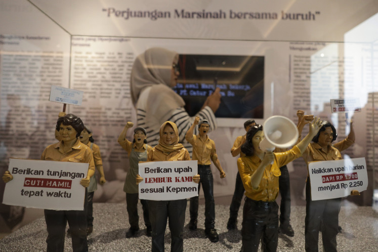 A visitor photographs a diorama with a mobile phone on May 16 at the Marsinah Museum in Nglundo village, Nganjuk, East Java. 
