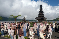 Holiday rush: Tourists walk near a lake on May 15, 2026, during a visit to Ulun Danu Beratan in Tabanan, Bali. The Ulun Danu Beratan management recorded that during the Ascension Day holiday period, visitor numbers reached about 2,200 per day, an increase from the usual daily average of 600 to 800 visitors.