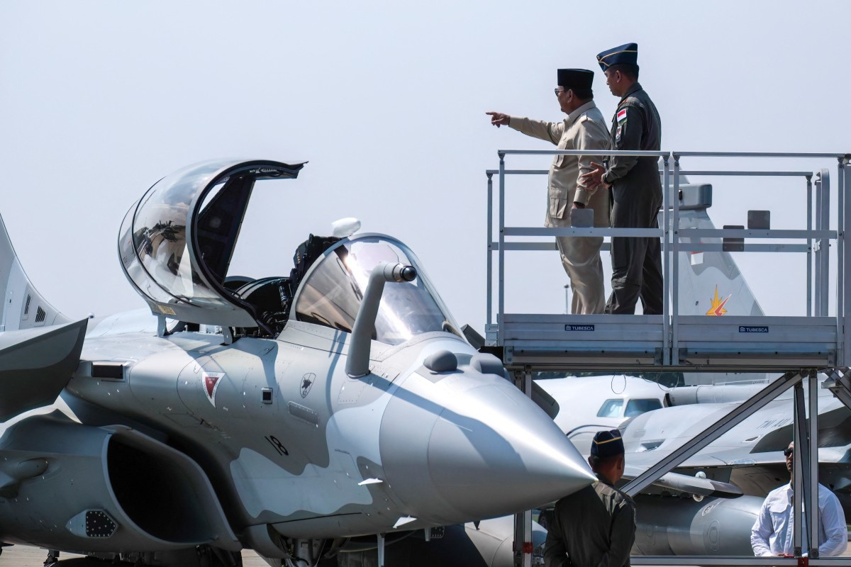 President Prabowo Subianto (2nd right) gestures as he looks inside the cockpit of a Rafale jet fighter during a ceremony on May 18 to hand over six new Rafale jet fighters, four Dassault Falcon 8X aircrafts and one Airbus A400M Atlas aircraft to the Indonesian Air Force at Halim Perdanakusuma Air Force Base in Jakarta. 