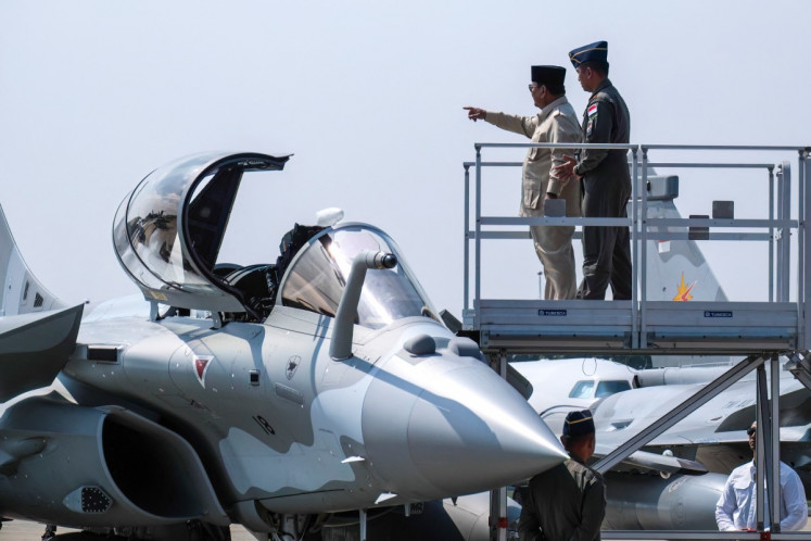 President Prabowo Subianto (2nd right) gestures as he looks inside the cockpit of a Rafale jet fighter during a ceremony on May 18 to hand over six new Rafale jet fighters, four Dassault Falcon 8X aircrafts and one Airbus A400M Atlas aircraft to the Indonesian Air Force at Halim Perdanakusuma Air Force Base in Jakarta. 