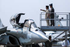 President Prabowo Subianto (2nd right) gestures as he looks inside the cockpit of a Rafale jet fighter during a ceremony on May 18 to hand over six new Rafale jet fighters, four Dassault Falcon 8X aircrafts and one Airbus A400M Atlas aircraft to the Indonesian Air Force at Halim Perdanakusuma Air Force Base in Jakarta. 
