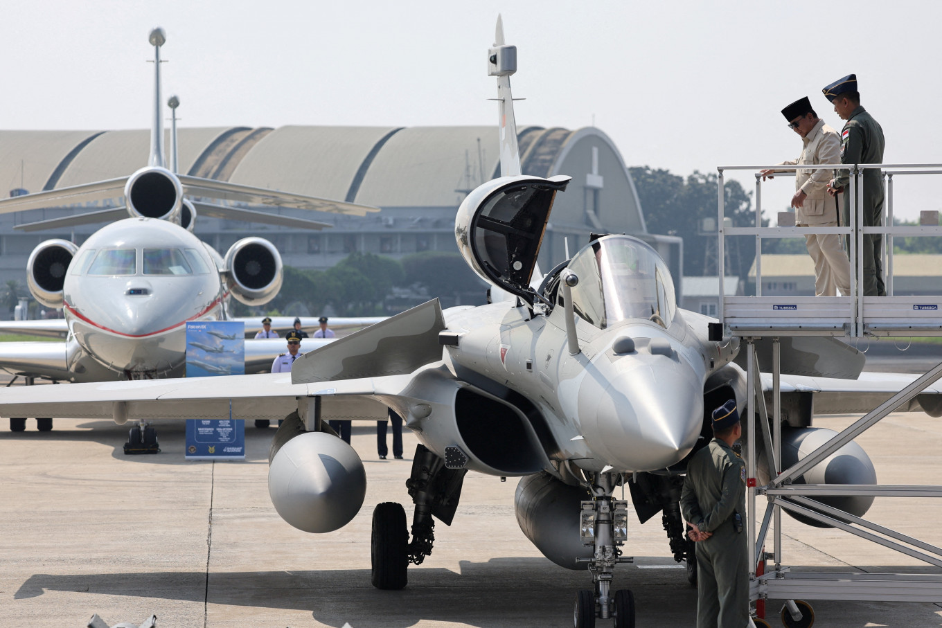 President Prabowo Subianto stands with an Air Force officer next to a Rafale fighter jet during a handover ceremony on May 18 for six Rafale fighter jets, one Airbus A400M military aircraft and four Dassault Falcon 8X military aircraft at Halim Perdanakusuma air base, in East Jakarta.