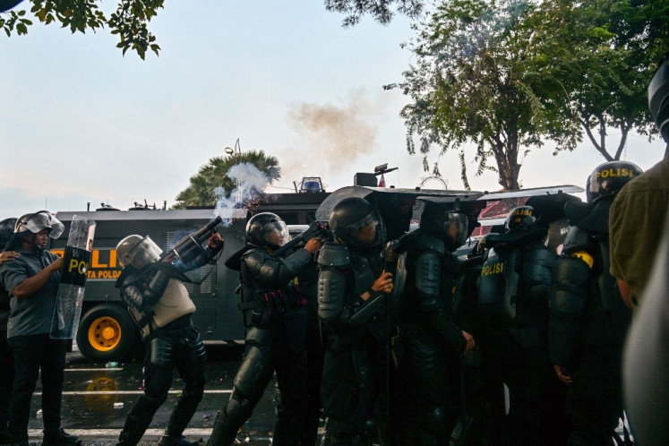 Police fire tear gas to disperse demonstrators during a protest against the Police Mobile Brigade (Brimob) in front of the East Java gubernatorial residence in Surabaya, East Java on Aug. 29, 2025, following the death of 21-year-old motorcycle transportation driver Affan Kurniawan, who was killed after being struck by a police tactical vehicle amid a protest against lavish allowances for lawmakers in Jakarta on Aug. 28.