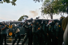 Police fire tear gas to disperse demonstrators during a protest against the Police Mobile Brigade (Brimob) in front of the East Java gubernatorial residence in Surabaya, East Java on Aug. 29, 2025, following the death of 21-year-old motorcycle transportation driver Affan Kurniawan, who was killed after being struck by a police tactical vehicle amid a protest against lavish allowances for lawmakers in Jakarta on Aug. 28.