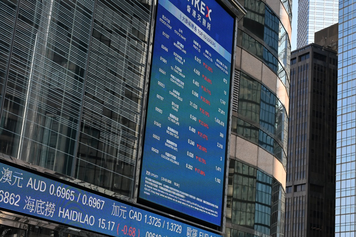 An electronic signboard shows the closing prices of stocks at the end of the day's trade outside the Hong Kong Exchanges and Clearing (HKEX) building in Hong Kong on March 23, 2026.