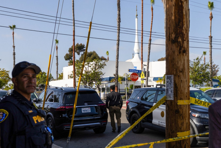 San Diego Police officers block the access to the Islamic Center of San Diego following a shooting in San Diego, the United States, on May 18, 2026. A shooting at the largest mosque complex in San Diego killed three people, with two suspected teenage gunmen later found dead in a car from self-inflicted gunshot wounds, police said.