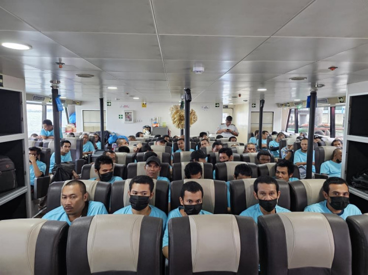 Indonesian deportees sit aboard a ferry during their trip from Malaysia to Batam Centre Point International Ferry Terminal in Batam, the Riau Islands, in this undated picture.