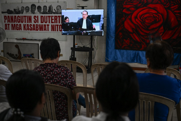 Families of victims in extrajudicial killings of former Philippine president Rodrigo Duterte's drug war watch a live stream on Feb. 26 of Duterte's confirmation hearing from The Hague, in Quezon City, Metro Manila. 