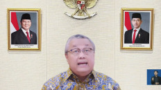 A screenshot shows Bank Indonesia (BI) Governor Perry Warjiyo presenting the results of BI's latest Board of Governors Meeting in an online press conference in Jakarta on May 20, 2026.