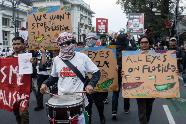 Activists hold a rally against Israel's interception of ships participating in the Global Sumud Flotilla, a civilian-led humanitarian aid mission to Gaza by sea, on May 19 in Bandung, West Java.