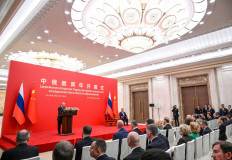 In this pool photograph distributed by the Russian state agency Sputnik, Russia's President Vladimir Putin and China's President Xi Jinping attend the opening ceremony of the Years of Russian-Chinese Cooperation in Education in Beijing on May 20, 2026. 