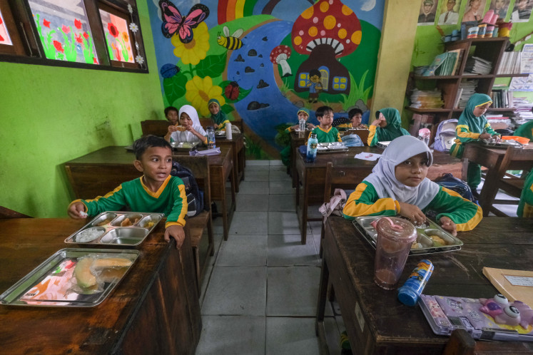 Pupils eat meals provided under the free nutritious meal program on May 21, 2026, at SD 2 state elementary school in Kendari, Southeast Sulawesi.